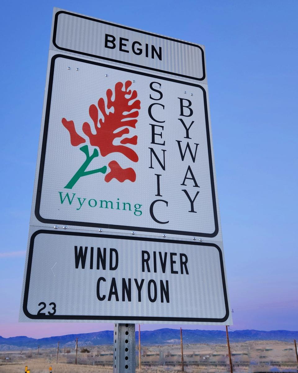 Wyoming Scenic Byway sign with Indian Paintbrush flower, Wind River Canyon